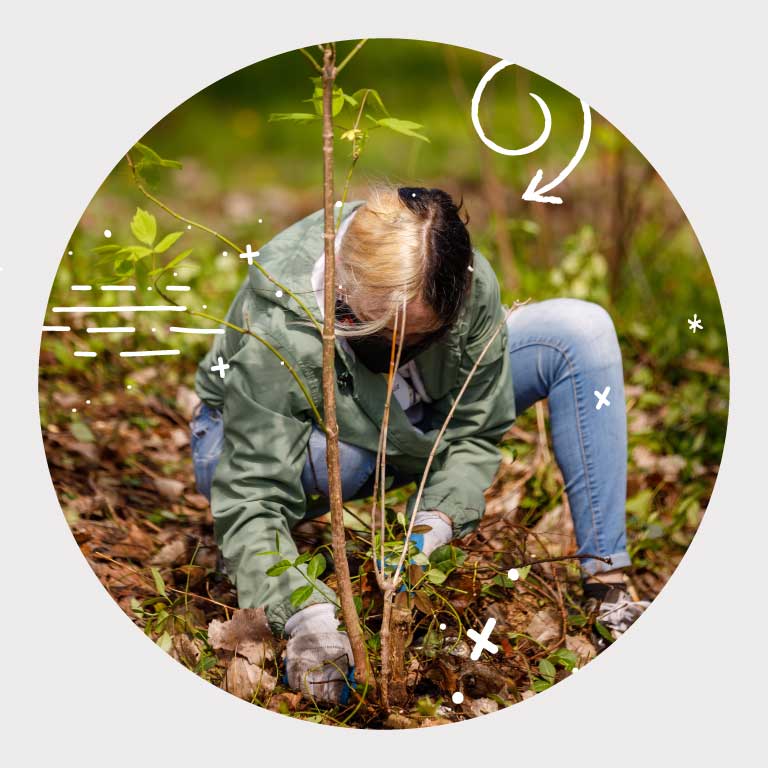 IU South Bend student volunteering to clean up campus and plant new trees on arbor day.
