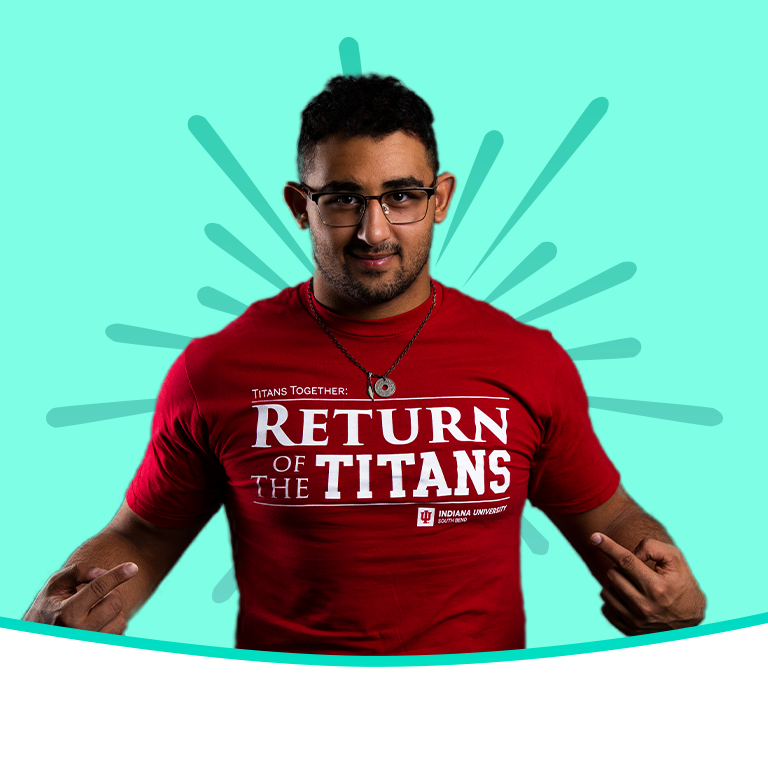 A male student pointing to his shirt on a green background with a green gradient burst behind him